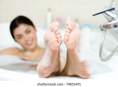 Image Of Soles Of Woman Having Pleasant Bath With Foam