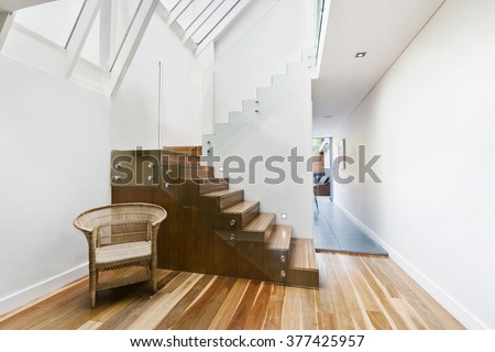 Image of solid wooden stairs with elegant glass balustrade