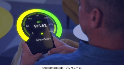 Image of speedometer data processing over caucasian businessman using tablet. Global business, digital interface, computing and data processing concept digitally generated image.