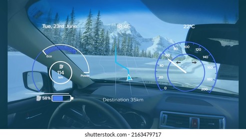 Image of speedometer, gps and charge data on interface, over car interior in winter landscape. transport and technology, engineering design and digital interface concept digitally generated image.