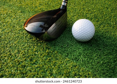 Image of a sports atmosphere with colorful golf balls, clubs, and tees placed on the green grass. - Powered by Shutterstock