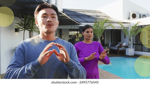 Image of spots of light over diverse couple exercising by swimming pool at home. Exercise, fitness, relationship, home and lifestyle concept digitally generated image. - Powered by Shutterstock