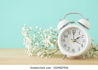 Image Of Spring Time Change. Summer Back Concept. Vintage Alarm Clock Over Wooden Table