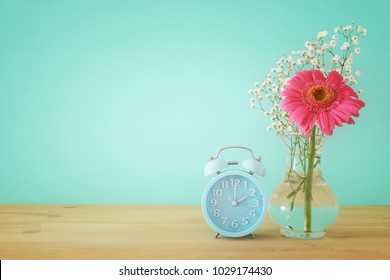 Image Of Spring Time Change. Summer Back Concept. Vintage Alarm Clock Over Wooden Table