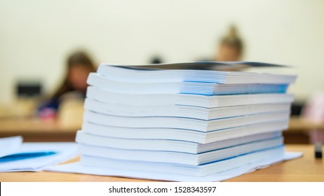 image of a stack of notebooks on the teacher's desk - Shutterstock ID 1528343597
