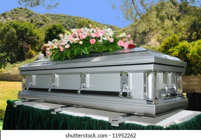 Image Of A Stainless Steel Casket With Flowers