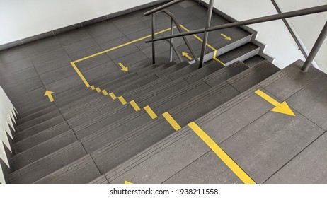 An image of staircase with signage arrow. This arrow due to the pandemic social distancing. Snap by smartphone - Shutterstock ID 1938211558