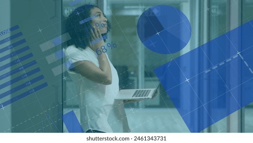 Image of statistical data processing against thoughful biracial woman using laptop at office. Computer interface and business data technology concept