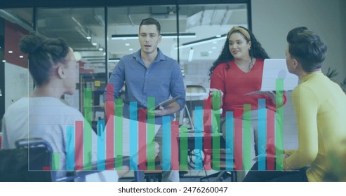 Image of statistical data processing against team of diverse colleagues discussing at office. Computer interface and business data technology concept