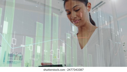 Image of statistical data processing over biracial woman using digital tablet smiling at office. Computer interface and business data technology concept - Powered by Shutterstock