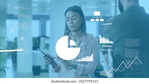 Image of statistical data processing over biracial woman talking to a male colleague at office. Computer interface and business data technology concept - Powered by Shutterstock