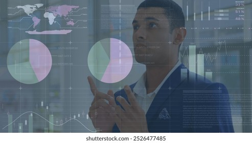 Image of statistics and financial data processing over biracial businessman. global data processing, business, finance and economy concept digitally generated image.