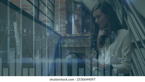 Image of statistics and financial data processing over businesswoman in office. Global business, finance, computing and data processing concept digitally generated image.
