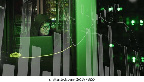 Image of statistics processing over asian male hacker in hoodie with laptop by computer servers. online cyber attack, cloud computing concept and technology concept digitally generated image.