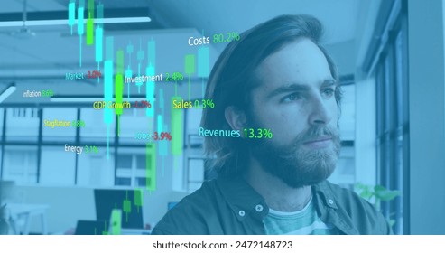 Image of stock market data processing against thoughtful caucasian man at office. Global economy and business technology concept