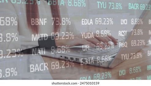 Image of stock market data processing against mid section of a woman using laptop. Global economy and business technology concept