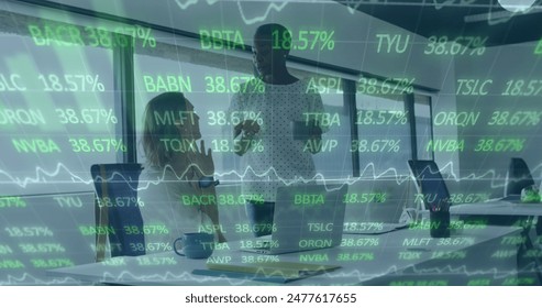 Image of stock market data processing over two diverse female colleagues discussing at office. Global economy and business technology concept