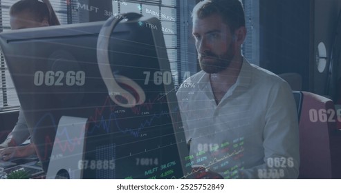 Image of stock market data processing against caucasian man using computer at office. Global economy and business technology concept