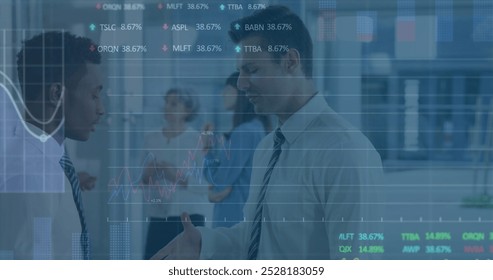 Image of stock market data processing over two diverse businesswomen discussing at office. Global economy and business data technology concept - Powered by Shutterstock