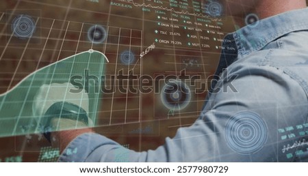 Image of stock market and data processing over caucasian man checking smartwatch. Global technology and digital interface concept digitally generated image.