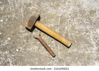 An image of a stone mason hammer and chisel