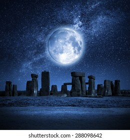 An image of Stonehenge with a full moon