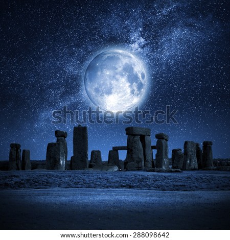 An image of Stonehenge with a full moon