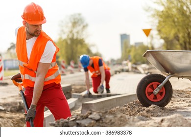 Image Of Strong Construction Worker Digging The Ground