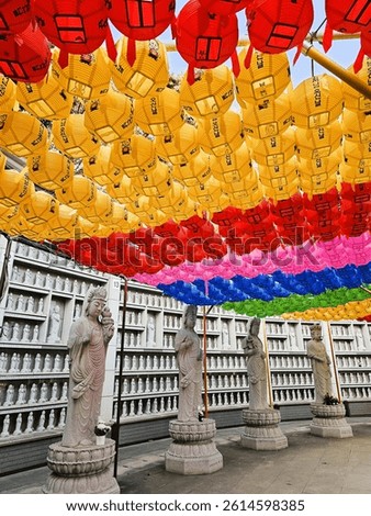 Image of stunning, colorful strings of different colored Korean paper lanterns that have Korean writing which means good luck, in the grounds of the Buddhist Bongeunsa Temple, in Seoul, South Korea.