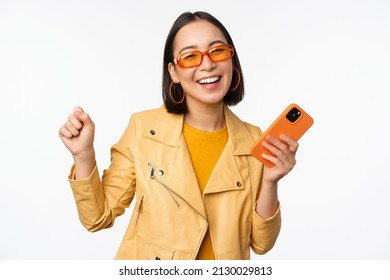 Image Of Stylish Korean Girl Dancing With Smartphone, Laughing Happy And Smiling, Standing Over White Background