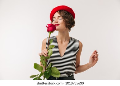 Image of stylish woman with short dark hair wearing red beret and holding rose isolated over white background - Powered by Shutterstock