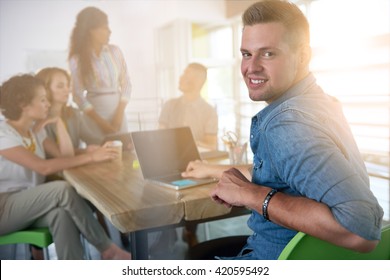 Image Of A Succesful Casual Business Man Using Laptop During Meeting