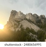 Image of the sun setting by Mount Rushmore