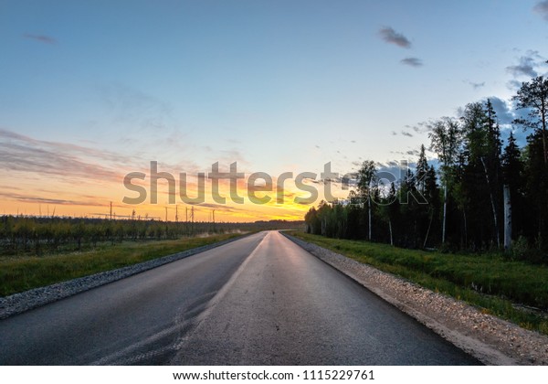 The image\
sunset on the road in the\
countryside