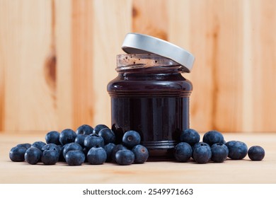 Image of sweet blueberry jam in jar and berries on wooden surface - Powered by Shutterstock