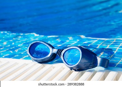 Image Of A Swimming Pool Goggles On The Poolside.