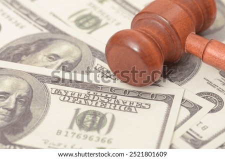 The image symbolizes the intersection of justice and finance, suggesting the role of money in legal proceedings or the financial implications of legal decisions.
