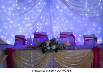 An Image Of Tables Setting At A Luxury Wedding Hall - Purple Lights