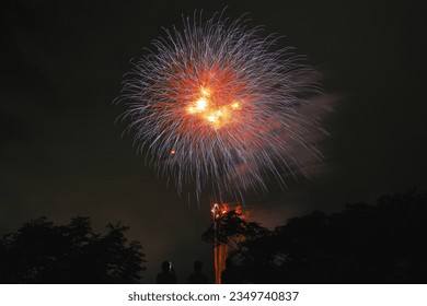 Image taken from the back of Japanese fireworks and spectators watching the fireworks - Shutterstock ID 2349740837