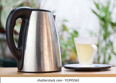 The image of a tea cup and a kettle