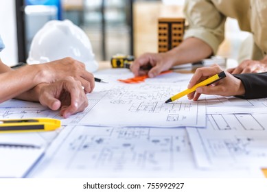 Image of team engineer checks construction blueprints on new project with engineering tools at desk in office.