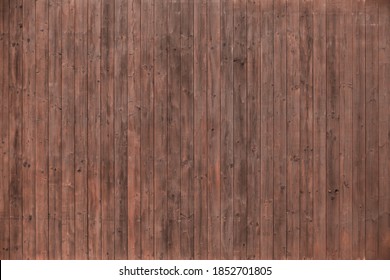 An Image Of A Texture From Deck Boards. Dark Mahogany, Vertical Planks. Without Fastening Elements. Wall Lined With Wood. Wooden Background For A Banner. Natural Material.