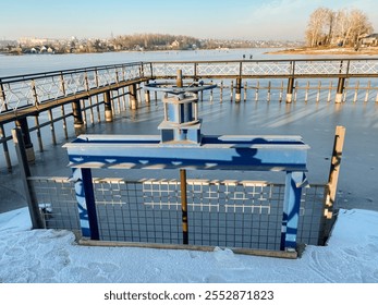 In the image, there is a picturesque frozen lake, and in the foreground, you can see a rustic fence that adds to the charm of the scene, surrounded by nature and beautiful landscapes - Powered by Shutterstock