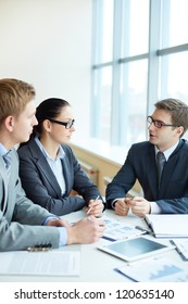 Image Of Three Business People Negotiating At Meeting