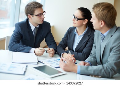 Image Of Three Business People Negotiating At Meeting