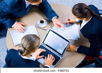 Image Of Three Business People Working At Meeting