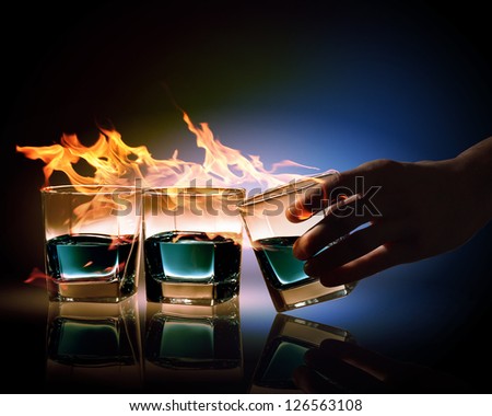 Image of three glasses of burning emerald absinthe