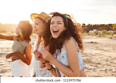 Image of three joyous multiethnic girls 20s in stylish clothing laughing and enjoying summertime during beach party at seaside - Powered by Shutterstock