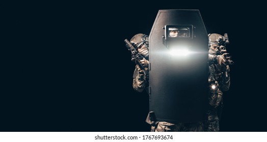 Image Of Three Soldiers In A Shooting Computer Game. They Hide Behind A Tactical Bulletproof Shield. Mixed Media