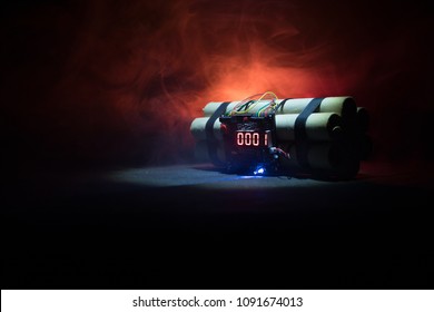 Image of a time bomb against dark background. Timer counting down to detonation illuminated in a shaft light shining through the darkness, conceptual image